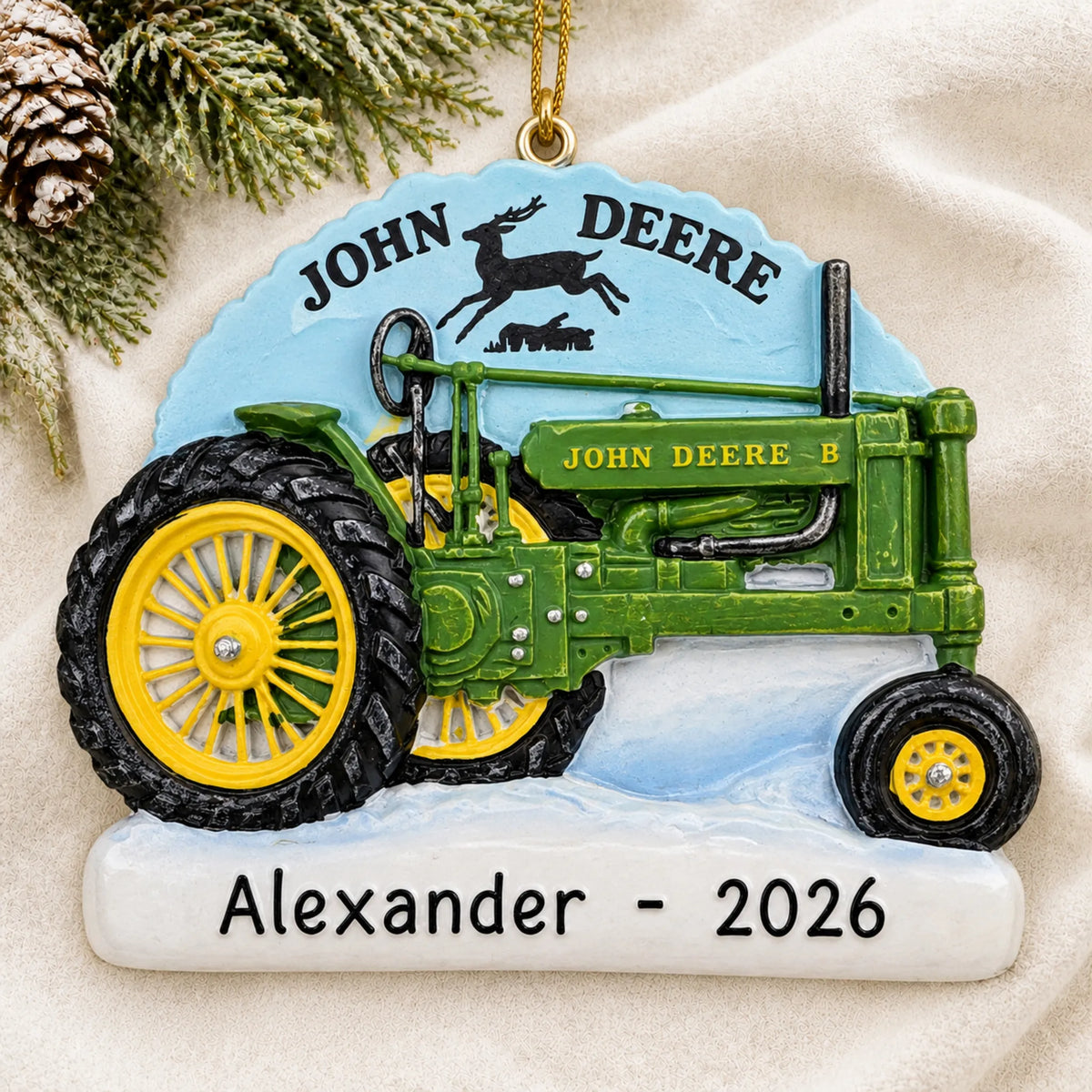 Personalized John Deere Model B Tractor christmas ornament laid on a soft white knit blanket