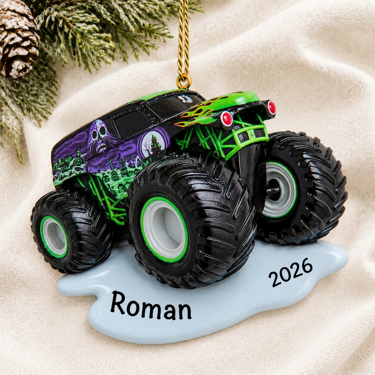 Personalized monster truck christmas ornament laid on a soft white knit blanket