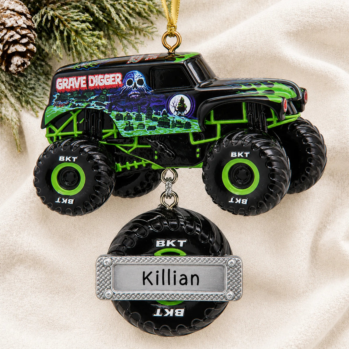Personalized Grave Digger Monster Truck christmas ornament laid on a soft white knit blanket