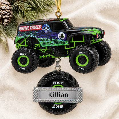 Personalized Grave Digger Monster Truck christmas ornament laid on a soft white knit blanket