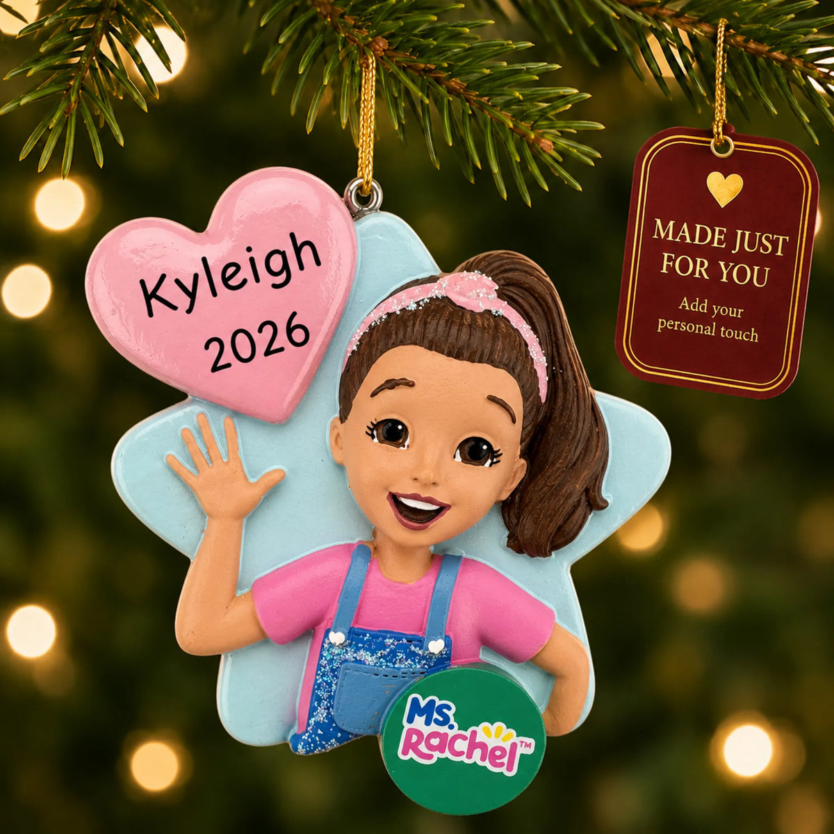Ms. Rachel christmas ornament hanging on a lit Christmas tree with a Made Just For You gift tag