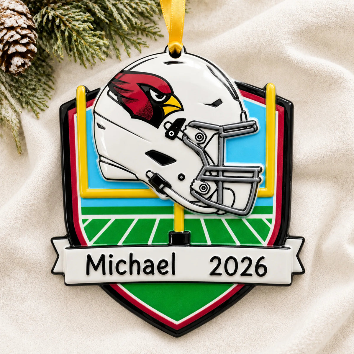 Personalized Arizona Cardinals NFL christmas ornament laid on a soft white knit blanket
