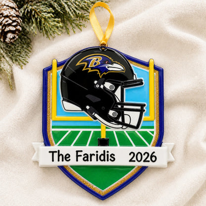 Personalized Baltimore Ravens NFL christmas ornament laid on a soft white knit blanket