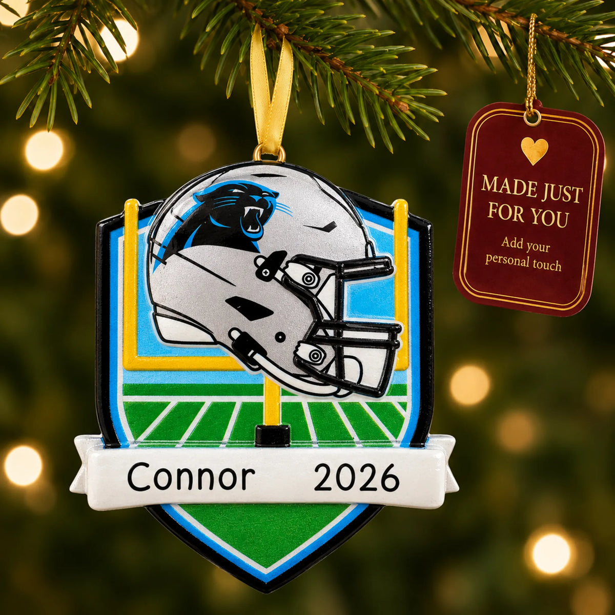 Carolina Panthers NFL christmas ornament hanging on a lit Christmas tree with a Made Just For You gift tag