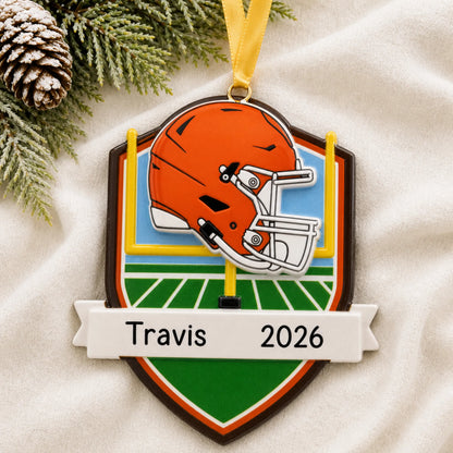 Personalized Cleveland Browns NFL christmas ornament laid on a soft white knit blanket
