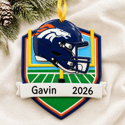 Personalized Denver Broncos NFL christmas ornament laid on a soft white knit blanket