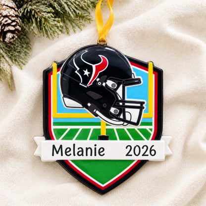 Personalized Houston Texans NFL christmas ornament laid on a soft white knit blanket