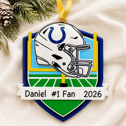 Personalized Indianapolis Colts NFL christmas ornament laid on a soft white knit blanket