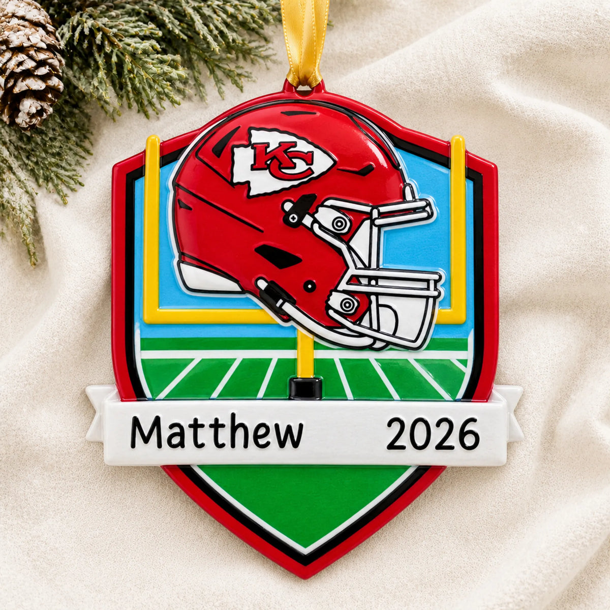 Personalized Kansas City Chiefs NFL christmas ornament laid on a soft white knit blanket