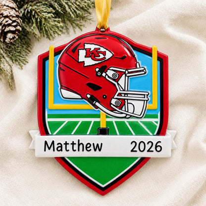 Personalized Kansas City Chiefs NFL christmas ornament laid on a soft white knit blanket