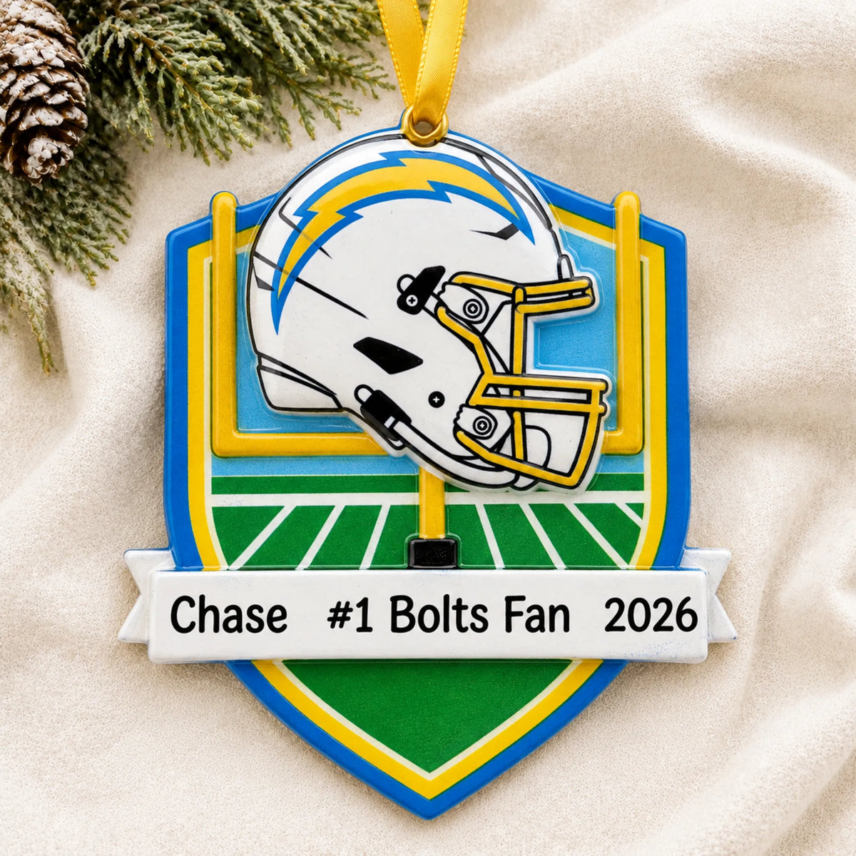 Personalized Los Angeles Chargers NFL christmas ornament laid on a soft white knit blanket