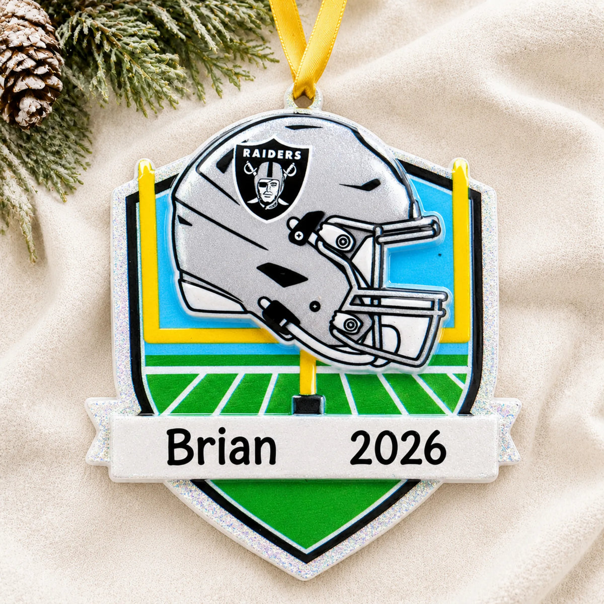Personalized Las Vegas Raiders NFL christmas ornament laid on a soft white knit blanket