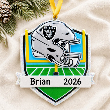 Personalized Las Vegas Raiders NFL christmas ornament laid on a soft white knit blanket