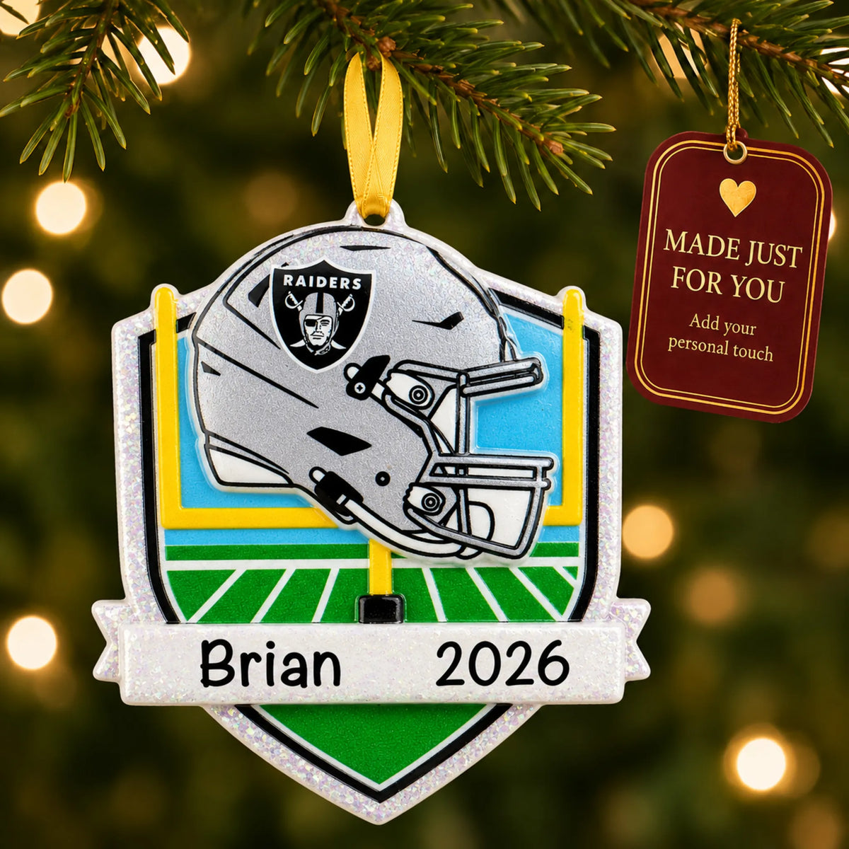 Las Vegas Raiders NFL christmas ornament hanging on a lit Christmas tree with a Made Just For You gift tag