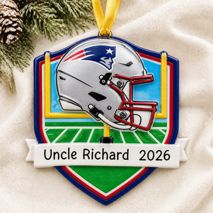Personalized New England Patriots NFL christmas ornament laid on a soft white knit blanket