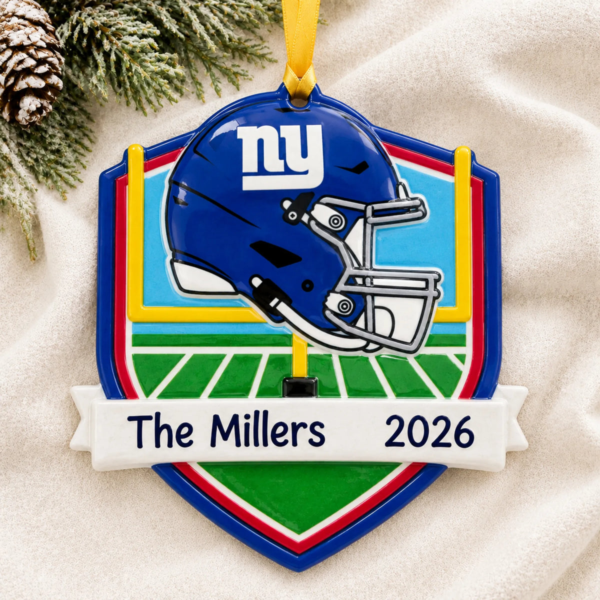 Personalized New York Giants NFL christmas ornament laid on a soft white knit blanket