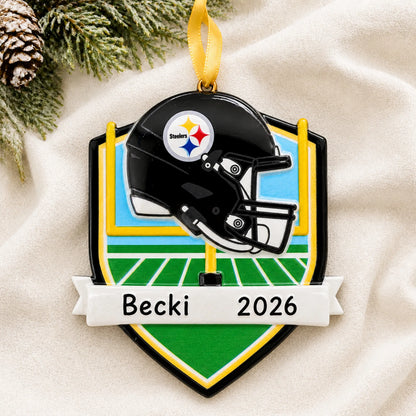 Personalized Pittsburgh Steelers NFL christmas ornament laid on a soft white knit blanket