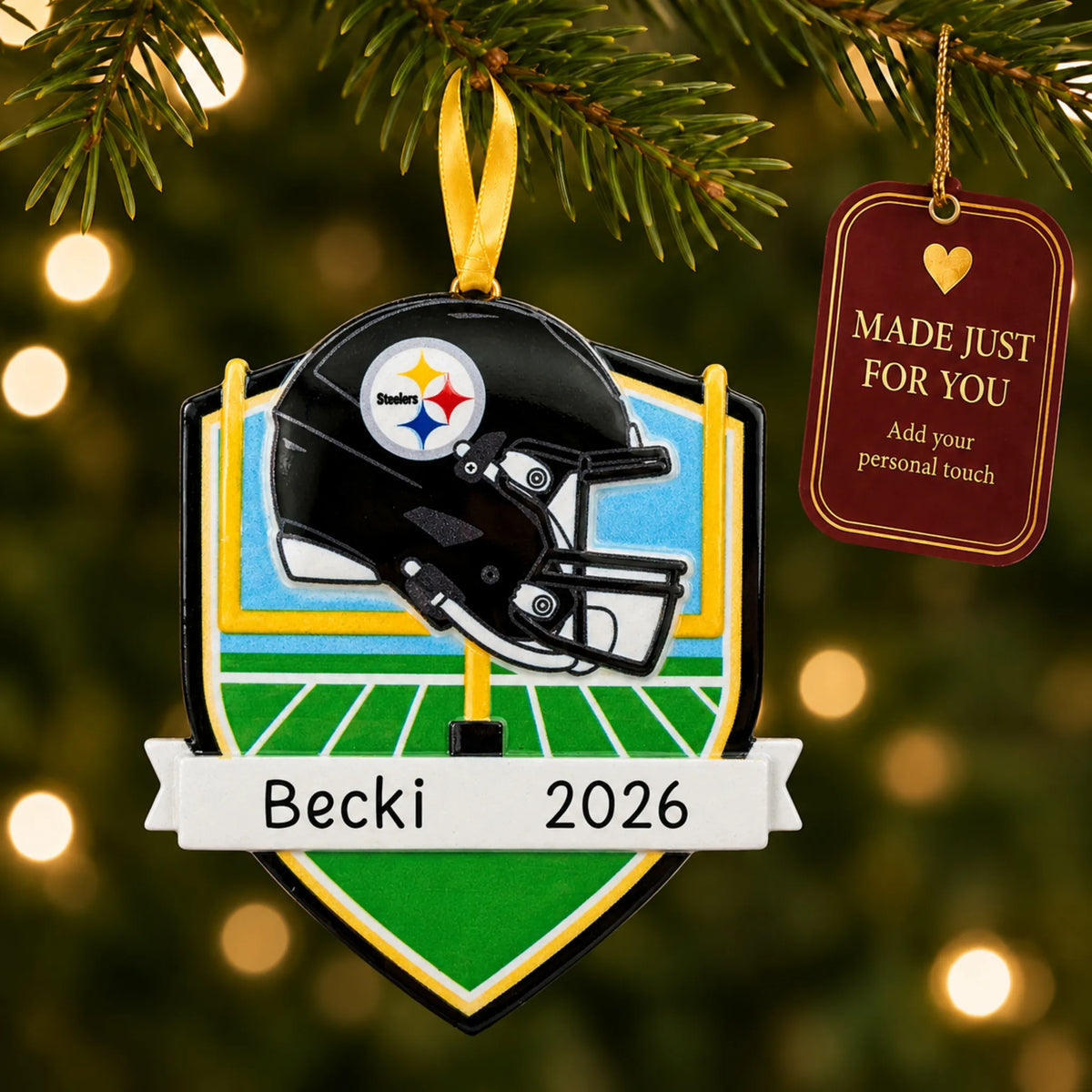 Pittsburgh Steelers NFL christmas ornament hanging on a lit Christmas tree with a Made Just For You gift tag