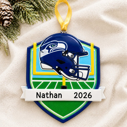 Personalized Seattle Seahawks NFL christmas ornament laid on a soft white knit blanket