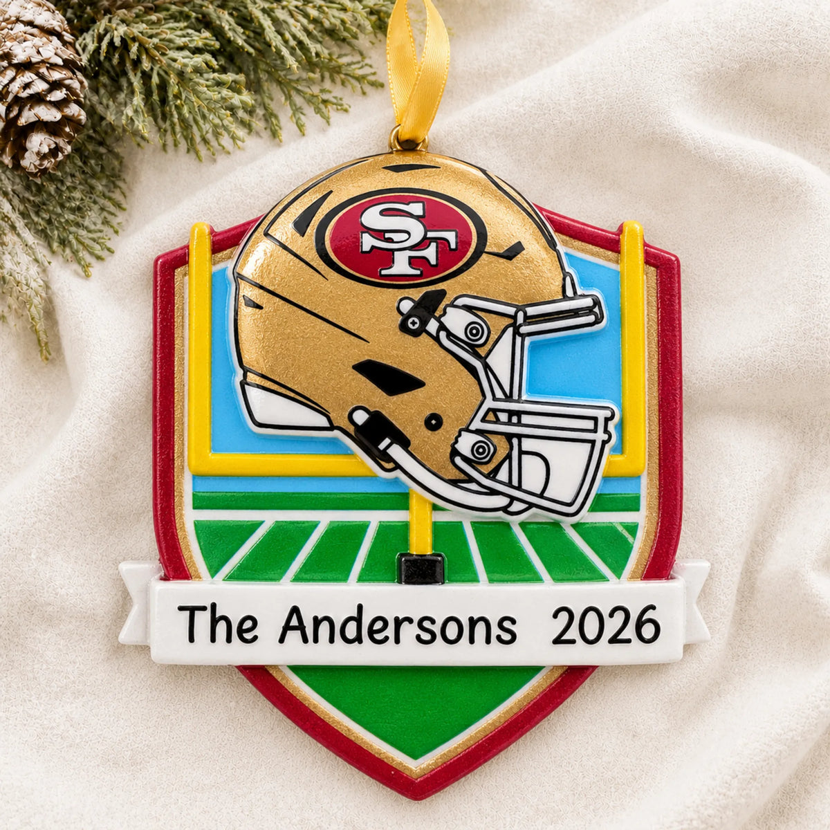 Personalized San Francisco 49ers NFL christmas ornament laid on a soft white knit blanket