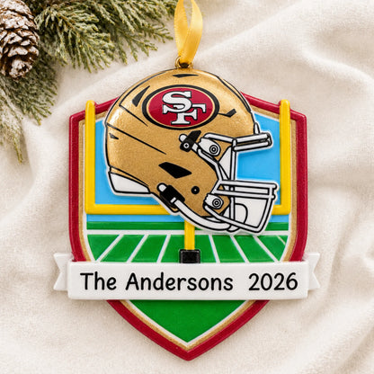 Personalized San Francisco 49ers NFL christmas ornament laid on a soft white knit blanket