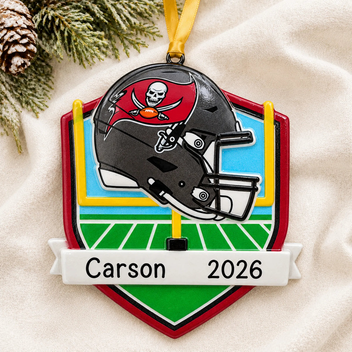 Personalized Tampa Bay Buccaneers NFL christmas ornament laid on a soft white knit blanket