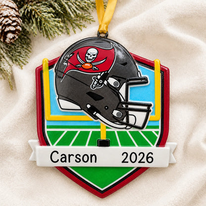 Personalized Tampa Bay Buccaneers NFL christmas ornament laid on a soft white knit blanket