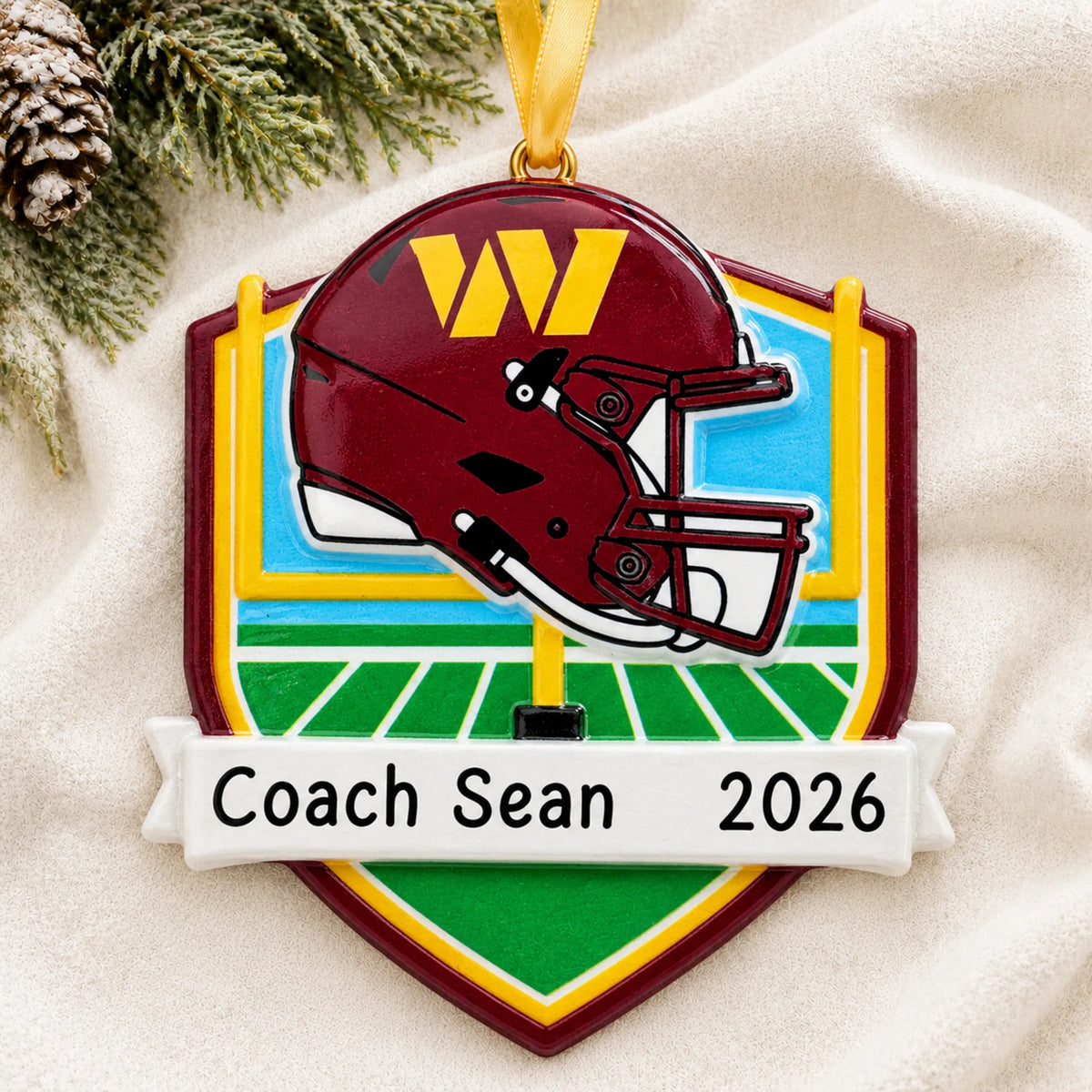 Personalized Washington Commanders NFL christmas ornament laid on a soft white knit blanket