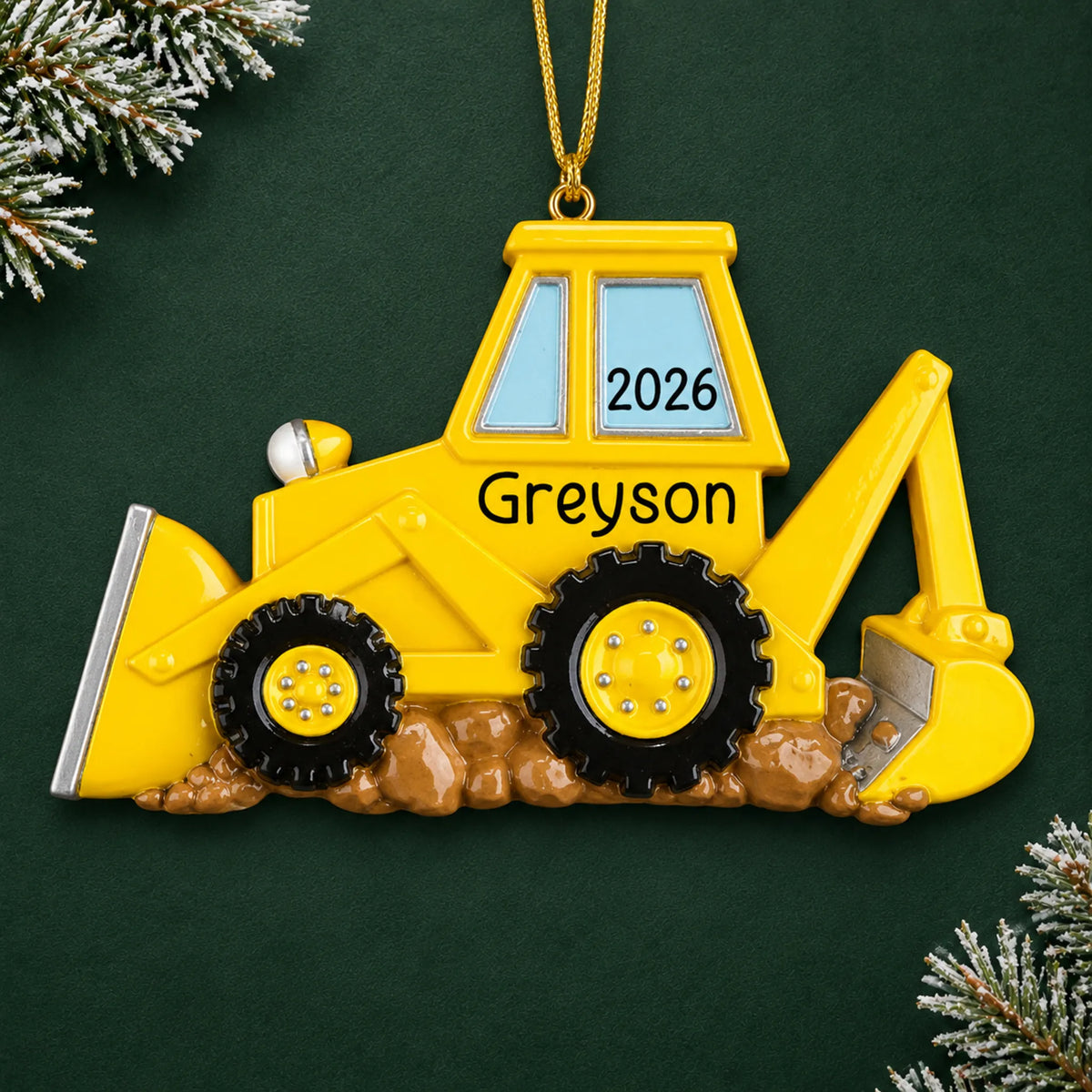 Personalized backhoe christmas ornament on a dark green pine background