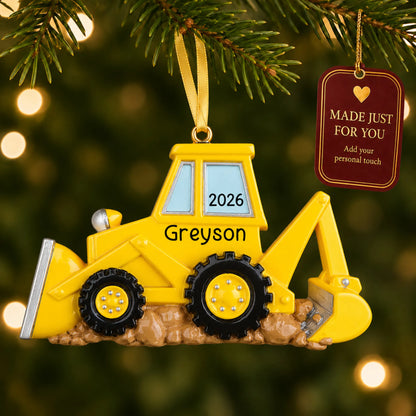 Backhoe christmas ornament hanging on a lit Christmas tree with a Made Just For You gift tag