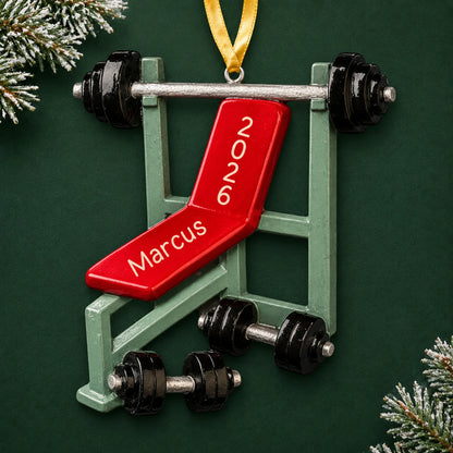 Personalized weight lifting bench christmas ornament on a dark green pine background