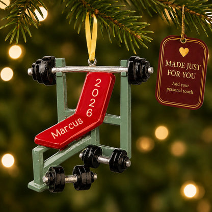Weight lifting bench christmas ornament hanging on a lit Christmas tree with a Made Just For You gift tag