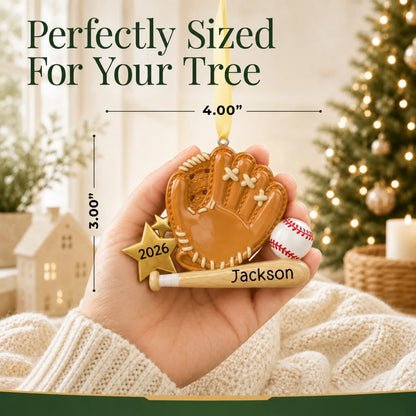 Size guide: the personalized baseball bat, glove and ball christmas ornament shown in hand next to a Christmas tree