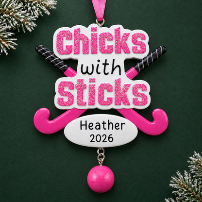 Personalized field hockey christmas ornament on a dark green pine background