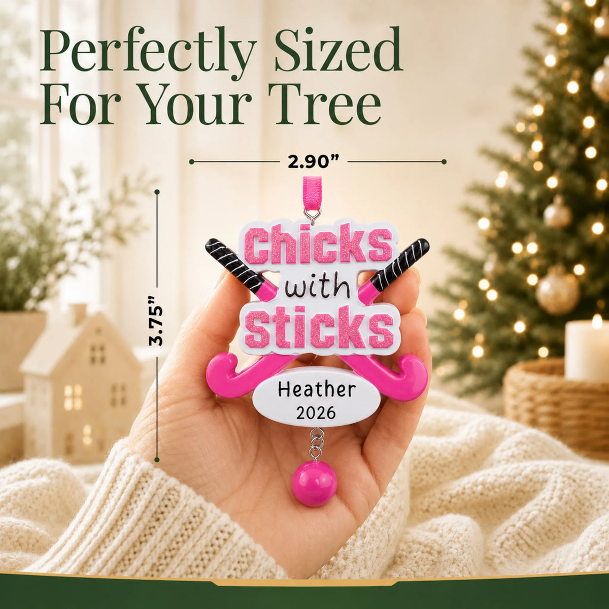 Size guide: the personalized field hockey christmas ornament shown in hand next to a Christmas tree