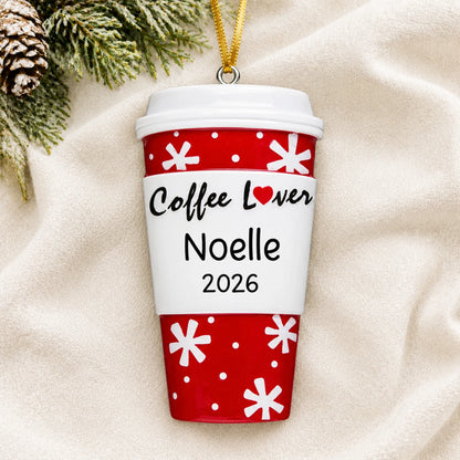 Personalized Coffee Lover Cup christmas ornament laid on a soft white knit blanket