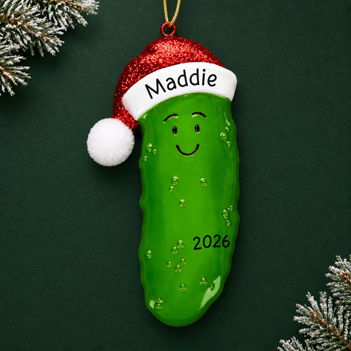 Personalized Christmas Pickle ornament on a dark green pine background