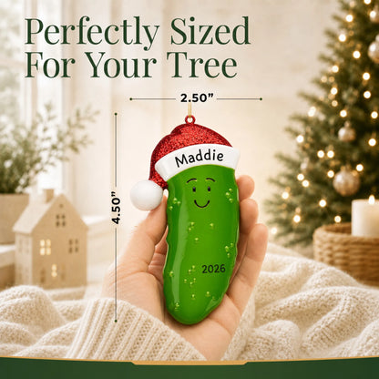 Size guide: the personalized Christmas Pickle ornament is 2.50 in wide by 4.50 in tall, shown in hand