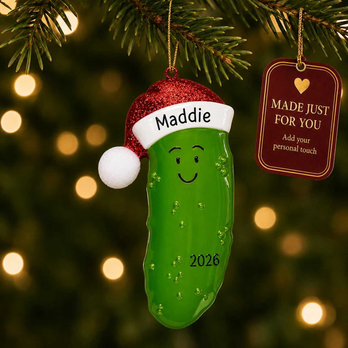 Christmas Pickle ornament hanging on a lit Christmas tree with a Made Just For You gift tag
