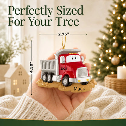 Size guide: the personalized construction dump truck christmas ornament is 2.75 in wide by 4.50 in tall, shown in hand