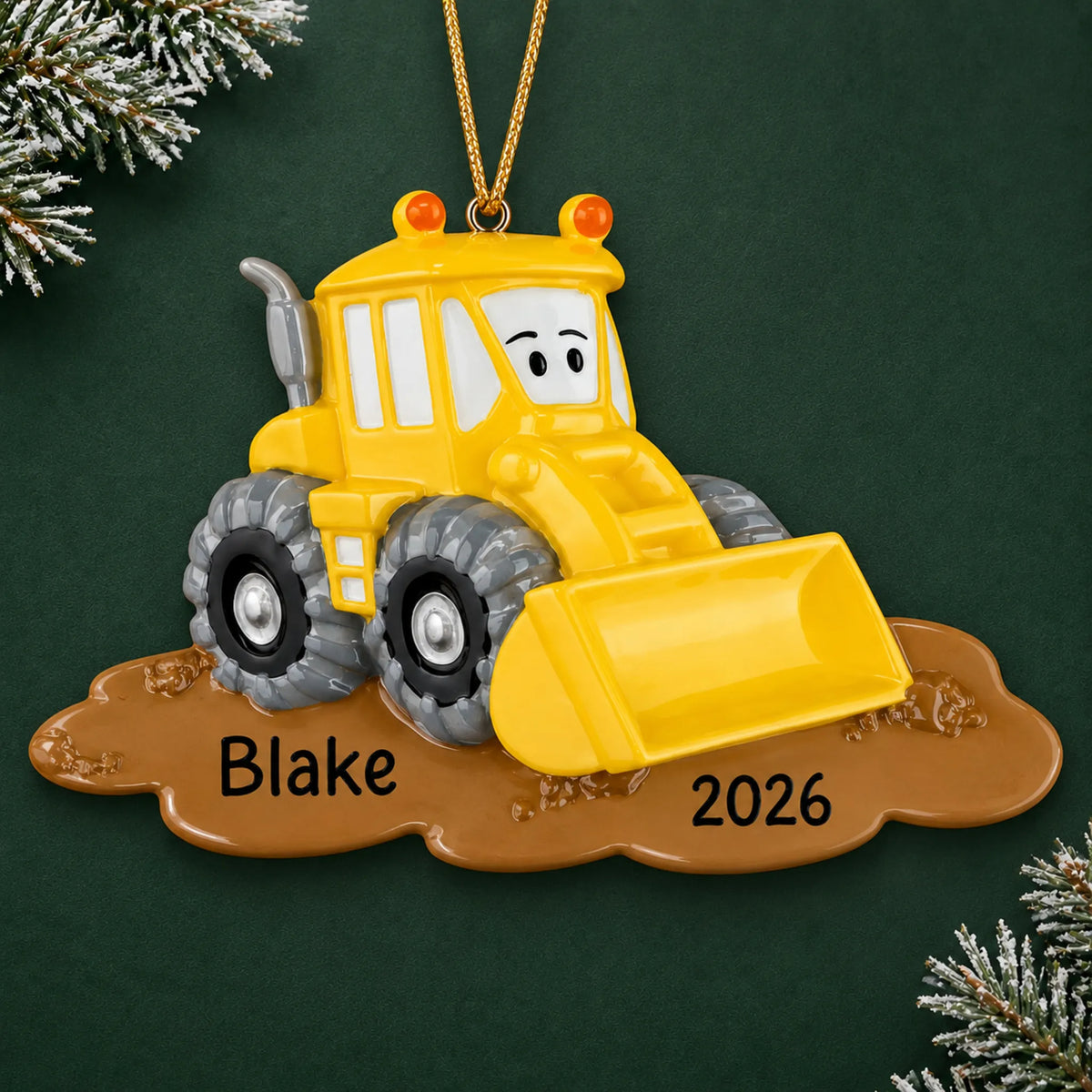 Personalized bulldozer christmas ornament on a dark green pine background