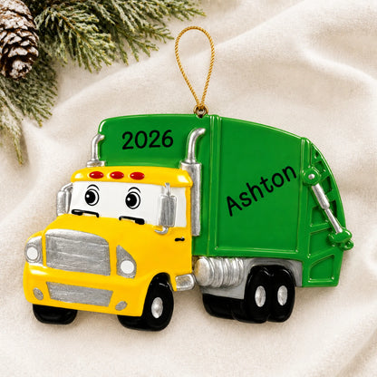 Personalized garbage truck christmas ornament laid on a soft white knit blanket