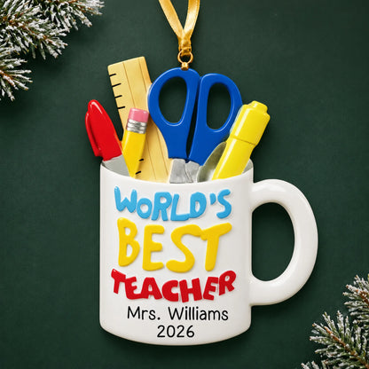 Personalized World's Best Teacher mug Christmas ornament with name and year, shown on a green holiday background