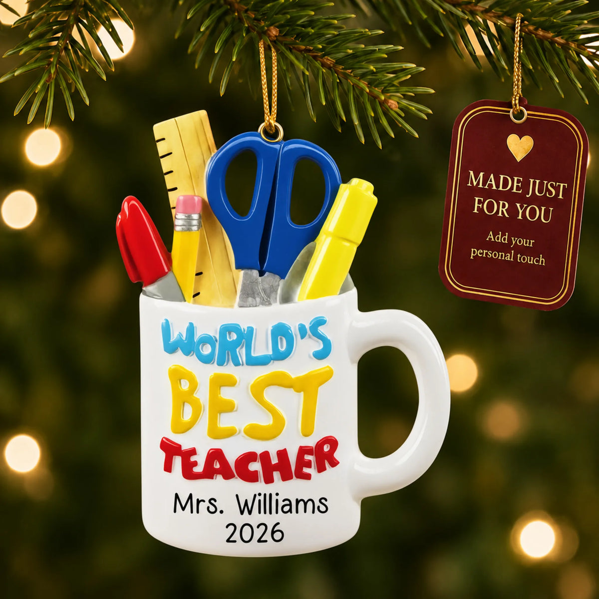 Personalized World's Best Teacher mug Christmas ornament hanging among tree lights with a Made Just For You tag