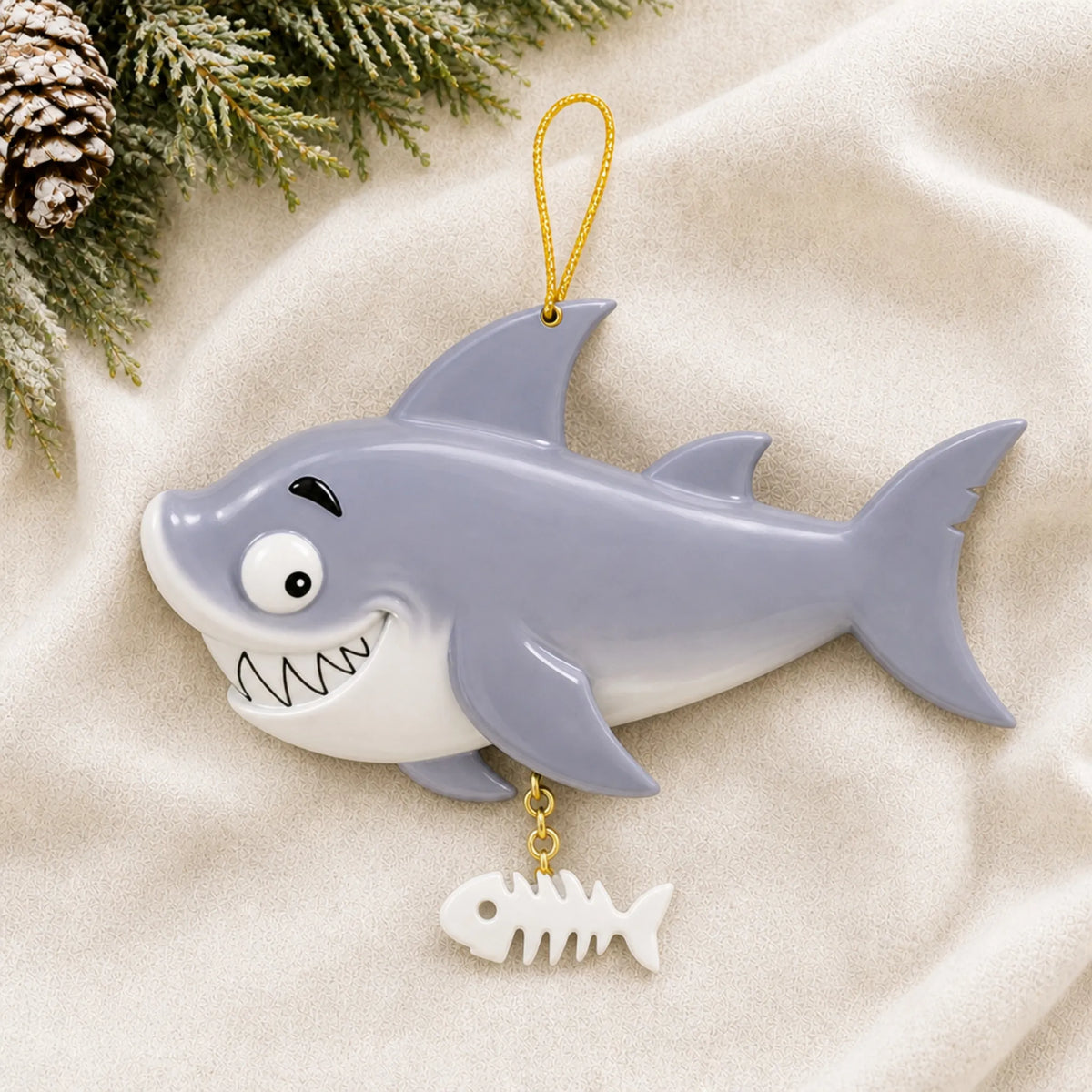 Personalized shark christmas ornament laid on a soft white knit blanket