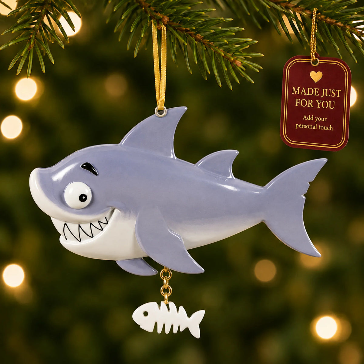 Shark christmas ornament hanging on a lit Christmas tree with a Made Just For You gift tag