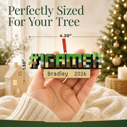Size guide: the personalized pixel block gamer christmas ornament is 4.20 in wide by 1.50 in tall, shown in hand