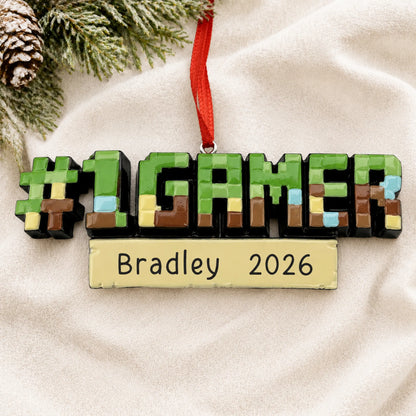 Personalized pixel block gamer christmas ornament laid on a soft white knit blanket