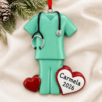 Personalized green scrubs christmas ornament laid on a soft white knit blanket