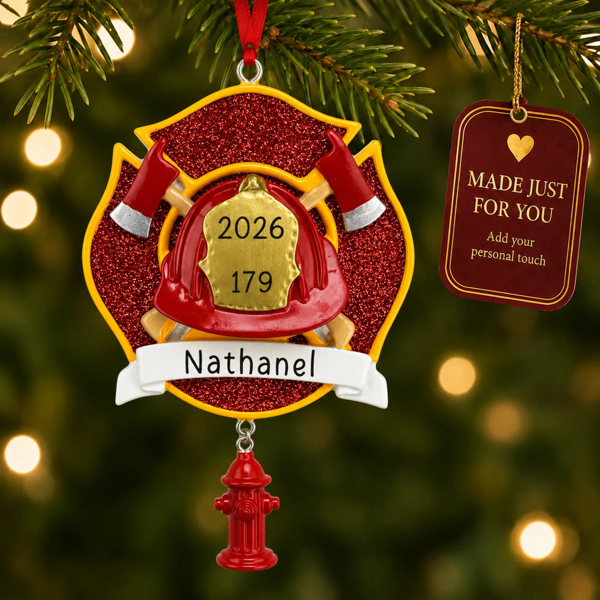 Firefighter emblem christmas ornament hanging on a lit Christmas tree with a Made Just For You gift tag